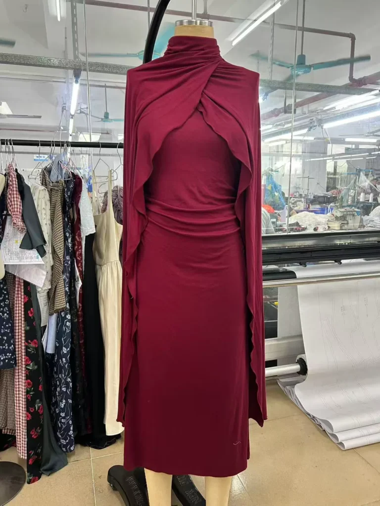Burgundy midi dress with a draped halter neckline and matching wrap on a mannequin.