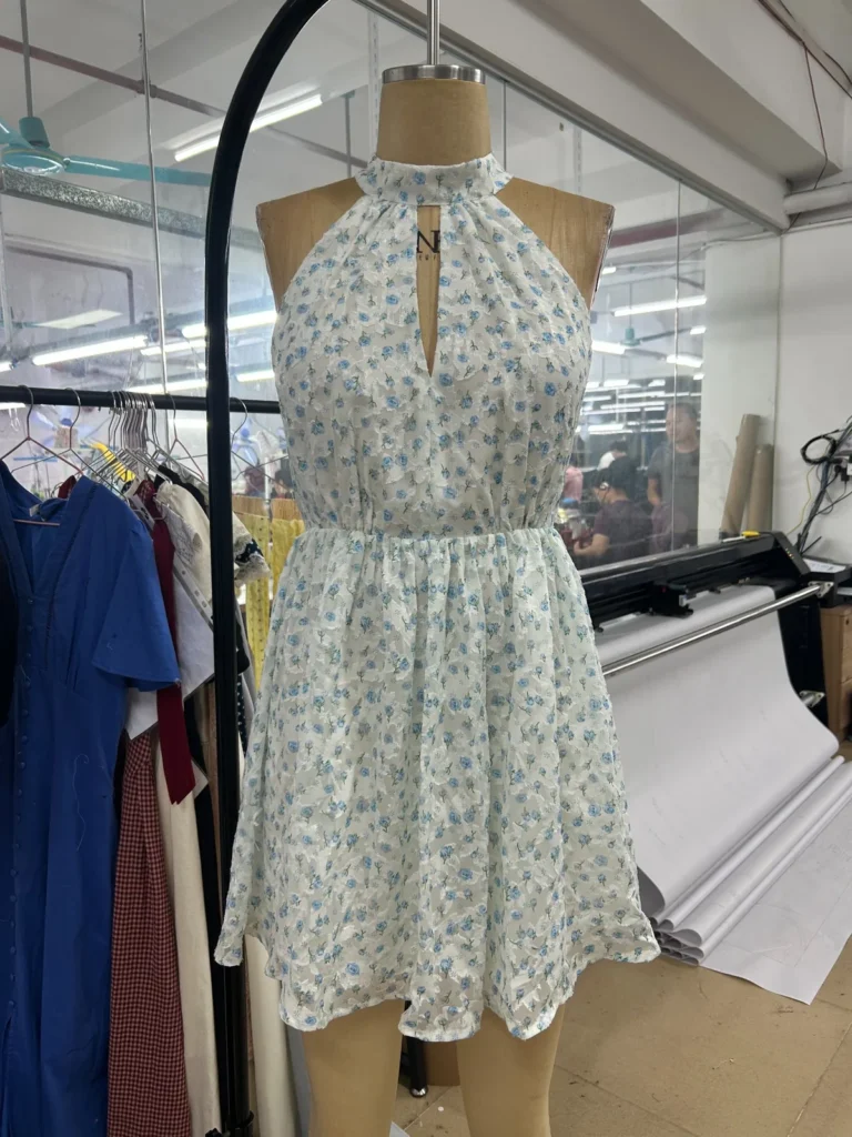 Floral halter-neck mini dress with a front keyhole opening on a mannequin.