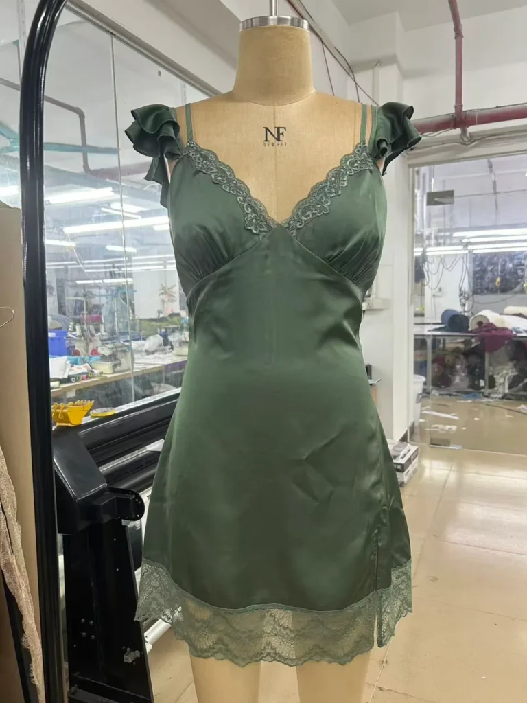 Olive green camisole with lace-trim neckline and hem on a mannequin.