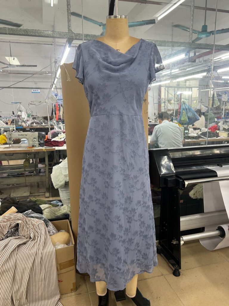 Blue floral cowl-neck midi dress displayed on a mannequin