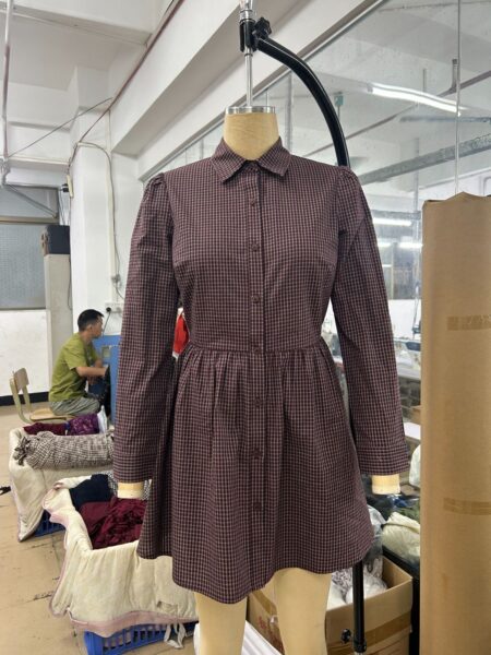 Brown check shirt dress sample with a structured collar and front neckline