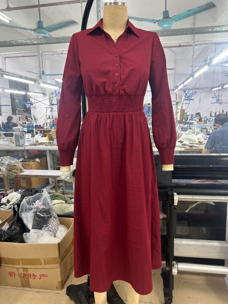 Burgundy long-sleeved shirt dress with a collar and gathered waist on a mannequin