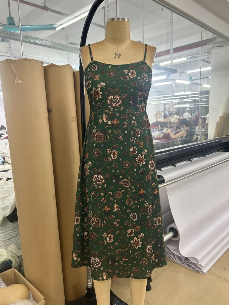 Green floral-print dress with thin shoulder straps on a mannequin