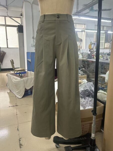 Olive wide-leg trousers displayed on a mannequin