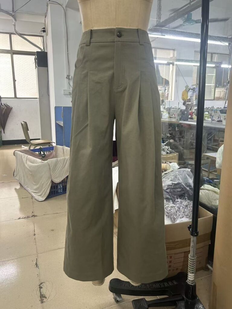 Olive wide-leg trousers displayed on a mannequin