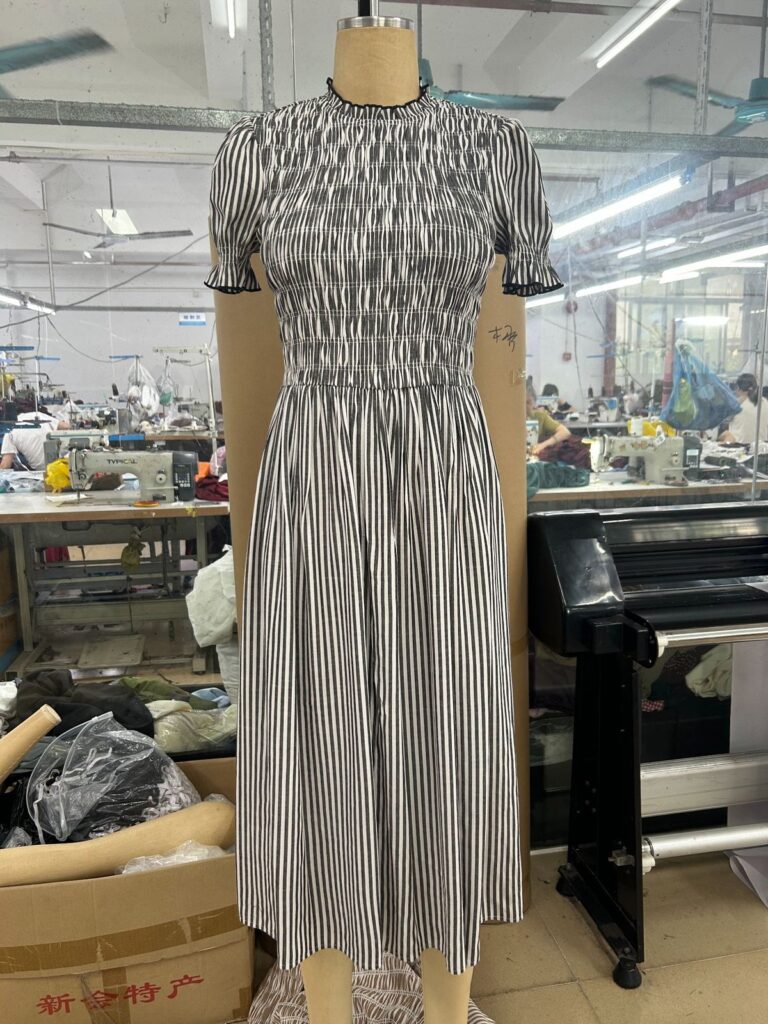 Striped smocked midi dress sample with gathered bodice and flared skirt