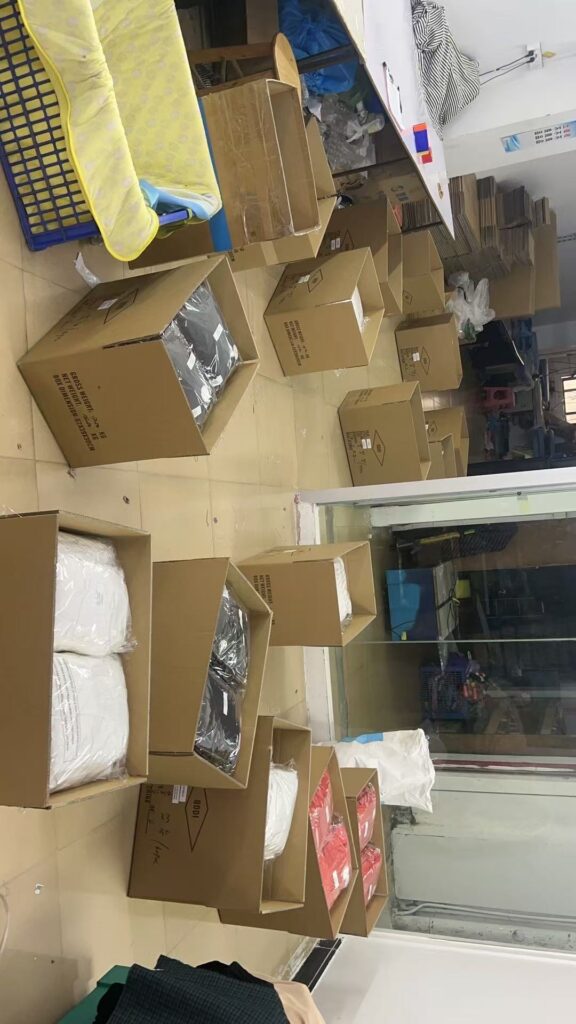 Open cardboard cartons and packing supplies arranged beside a workshop window