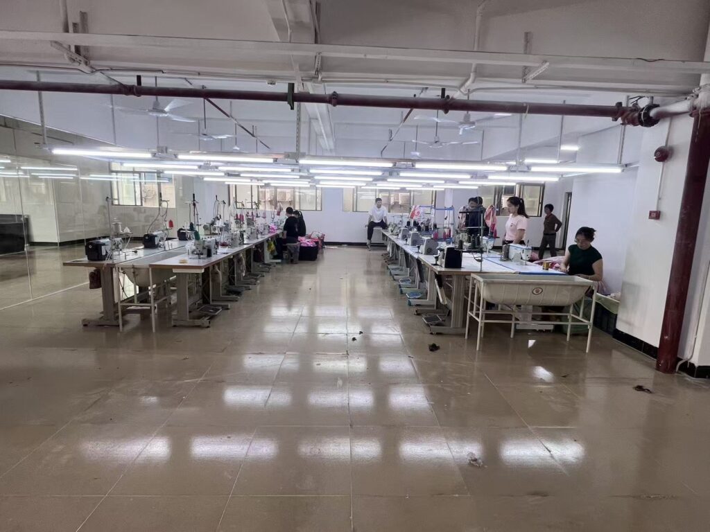 Two rows of sewing workstations separated by a wide central aisle
