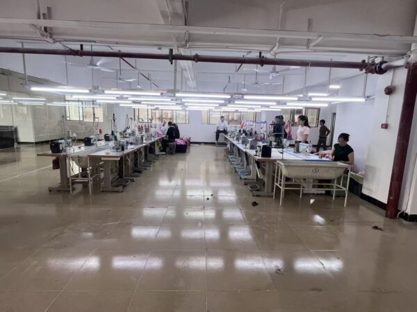 Two rows of sewing workstations separated by a wide central aisle