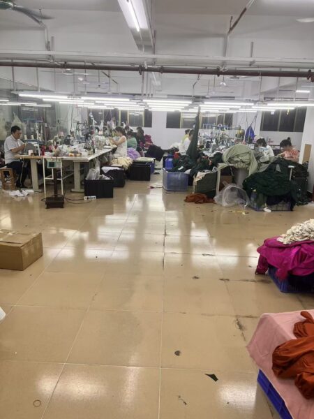 Central aisle between clothing production workstations and garment bundles
