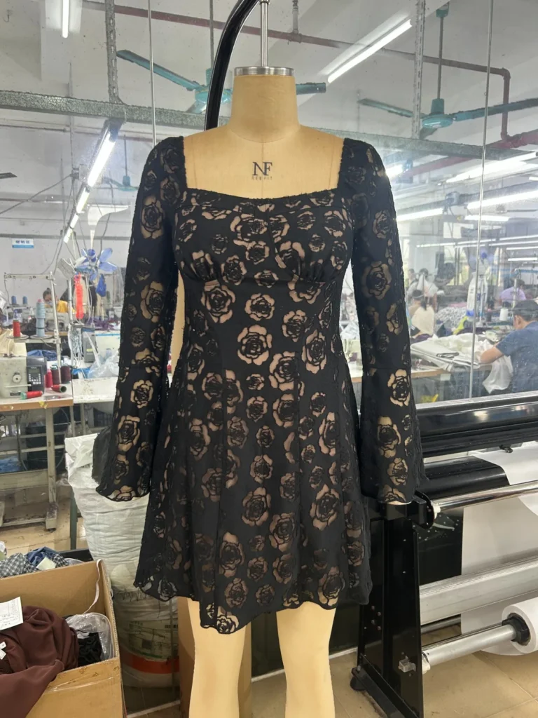 Black floral lace long-sleeve mini dress with a square neckline on a mannequin