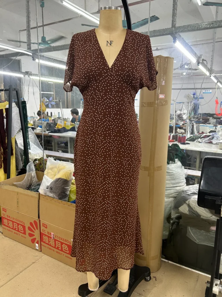 Brown small-print V-neck short-sleeve midi dress on a mannequin