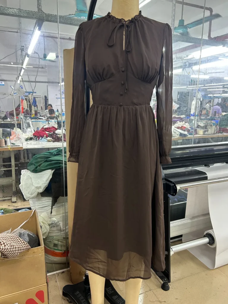 Brown tie-neck long-sleeve midi dress on a mannequin
