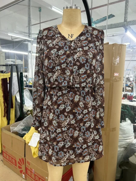 Long-sleeve floral mini dress displayed on a mannequin
